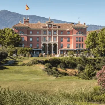 Pink palace façade and landscaped grounds at Anantara Villa Padierna