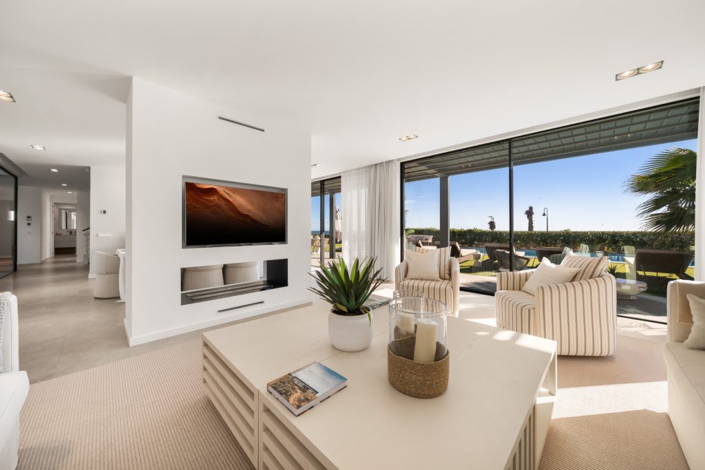 Living room opening towards the garden through broad glazing — El Saladillo Beachfront Residence