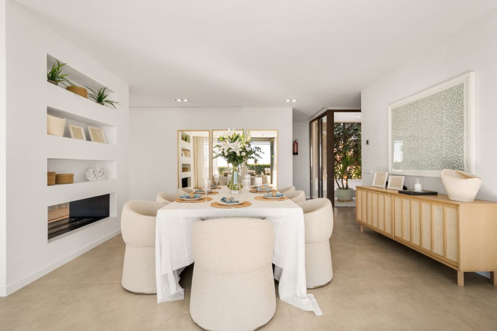 Dining area with warm timber cabinetry beside the living space — El Saladillo Beachfront Residence