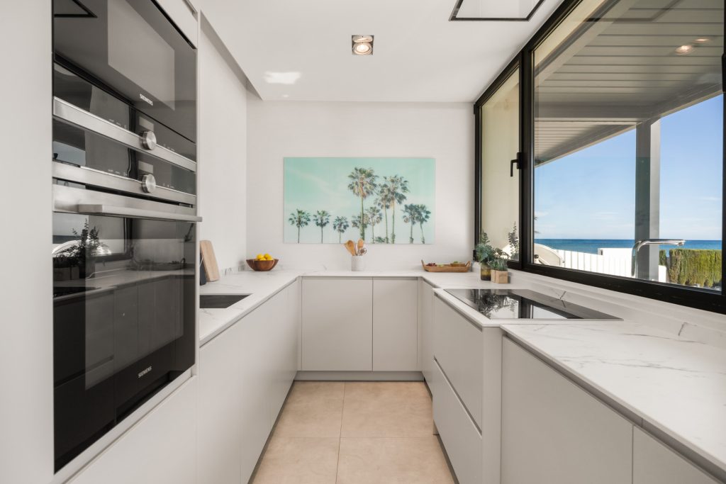 Separate kitchen with a garden-facing window — El Saladillo Beachfront Residence