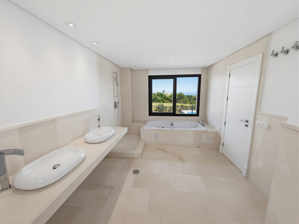 Bathroom with twin basins and a bathtub — La Reserva Residence