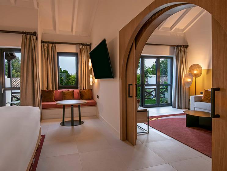 SO/ Two suite with an arched doorway between its living and sleeping areas