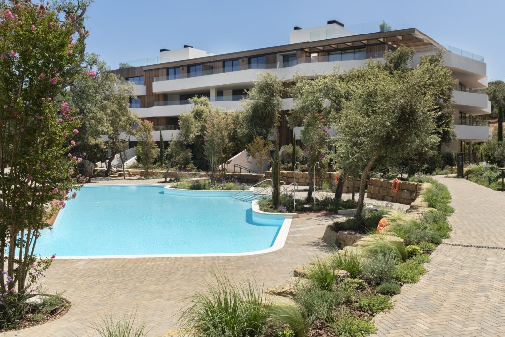 Village Verde apartment buildings, landscaped gardens and communal swimming pool in Sotogrande